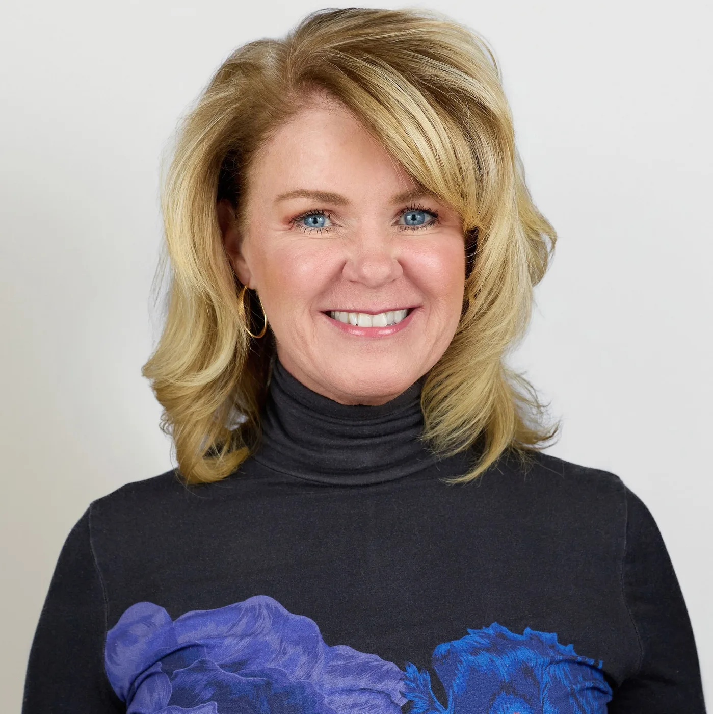 Portrait of Ann Marie Houlihan smiling in a dark turtleneck