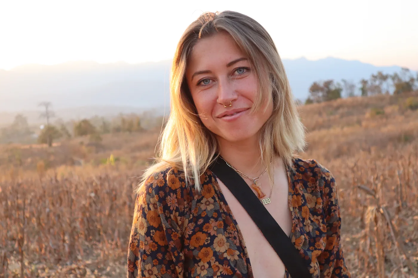 Portrait of Kenna Johnson in golden evening light with mountains behind her